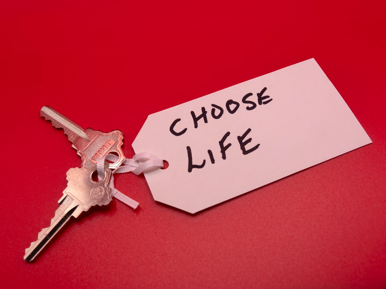 services-04 Keys on a red background with a 'Choose Life' tag, symbolizing decision-making.